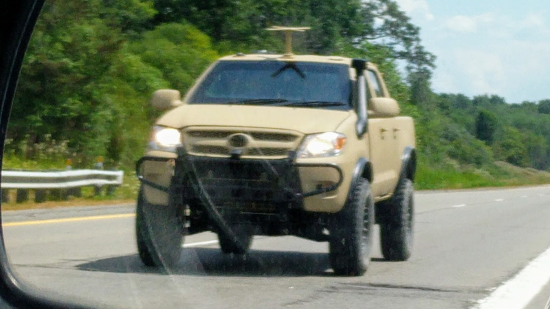 Illustration for article titled Check Out This Militarized Toyota Hilux and Its Weird Door Handles
